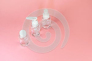 Beauty cosmetics glassbottle; branding mock up; front view on pastel pink background.