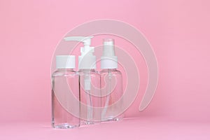 Beauty cosmetics glassbottle; branding mock up; front view on pastel pink background.