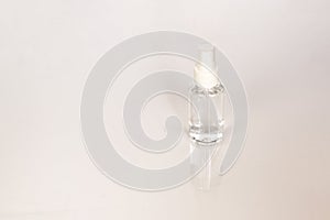 Beauty cosmetics glassbottle; branding mock up; front view on pastel white background.