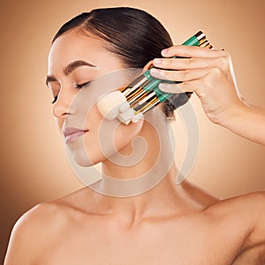 Beauty, cosmetics and makeup, woman with brushes on face, aesthetic brown background and studio profile. Skincare