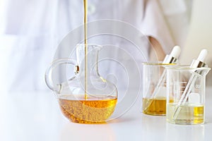 Beauty cosmetics sciences, Formulating and mixing skincare with herbal essence, Scientist pouring organic essential oil