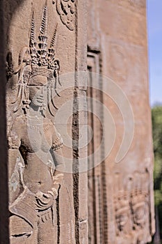 Beauty Dancing Apsaras an old Khmer art sand stone carving of Apsara status on the wall at world heritage, Siem Reap, Cambodia