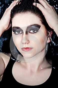 Beauty with dark make-up in the water