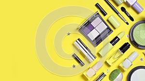 Beauty, decorative cosmetics. Makeup brushes set and color eyeshadow palette on yellow background