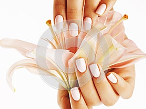 Beauty delicate hands with manicure holding flower