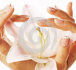 Beauty delicate hands with manicure holding flower