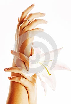 Beauty delicate hands with manicure holding flower lily close up