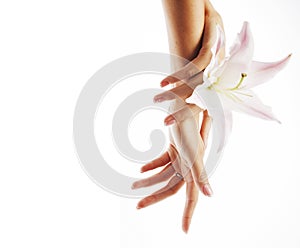 Beauty delicate hands with manicure holding flower lily