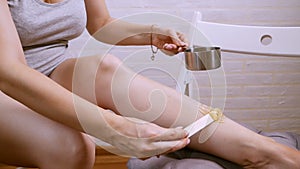 Beauty, depilation, epilation, hair removal and people concept - beautiful woman with applicator applying depilatory wax