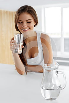 Beauty, Diet Concept. Happy Smiling Woman Drinking Water. Health