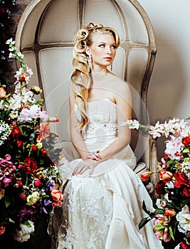 Beauty emotional blond bride in luxury interior dreaming, crazy complicate hairstyle