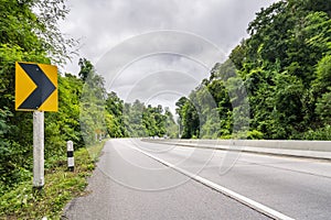 Beauty empty highway road with traffic signs and tree on cloudy sky background