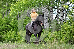 Beauty equestrian model ride a horse through a summer foresth