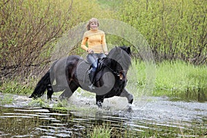 Beauty equestrian model ride a horse through a summer foresth