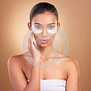 Beauty, eye patch and portrait of Indian woman in studio for facial, spa treatment and glow. Self care, cosmetics and