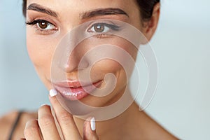 Beauty Face. Beautiful Woman Touching Lips With Lip Balm On