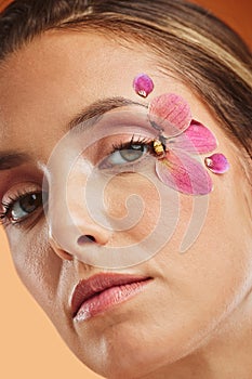 Beauty, face and cosmetic, woman and flower petal, eyes and natural makeup advertising closeup. Young model in portrait