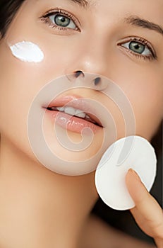Beauty, face cream and skincare cosmetics model portrait, woman applying moisturiser, cleanser or make-up remover