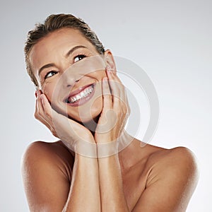 Beauty, face and happy mature woman glowing skincare, dermatology and anti aging cosmetics on grey studio background in