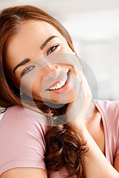 Beauty, face and skincare with a woman giving a smile and happy in her home. Closeup portrait of a young female with