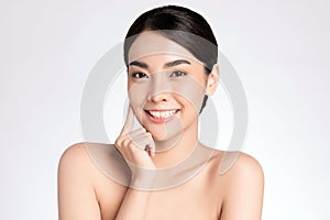 Beauty face. Smiling asian woman touching healthy skin portrait. Beautiful happy girl model with fresh glowing hydrated facial