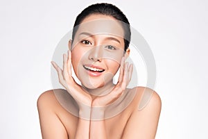 Beauty face. Smiling asian woman touching healthy skin portrait. Beautiful happy girl model with fresh glowing hydrated facial