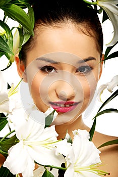 Beauty face of a woman with flowers.