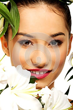 Beauty face of a woman with flowers.