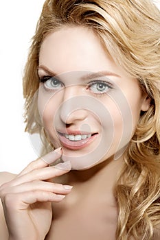 Beauty face woman. Girl healthy model in spa salon. Cream treatment products. Facial skin terapy. Beautiful smile, teeth. Dental photo