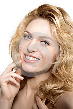 Beauty face woman. Girl healthy model in spa salon. Cream treatment products. Facial skin terapy. Beautiful smile, teeth. Dental photo