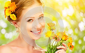 Beauty face of woman with orange yellow flowers