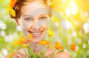 Beauty face of woman with orange yellow flowers