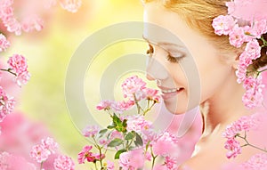 Beauty face of young beautiful woman with pink flowers in her ha