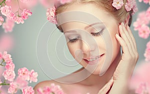 Beauty face of young beautiful woman with pink flowers