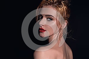 Beauty face of young blonde woman. Sexy model posing in studio. Portrait of beautiful girl. Beauty woman face closeup