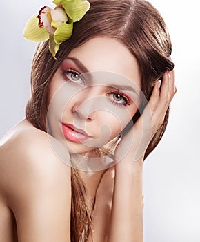 Beauty face young sensual woman with orchid flower