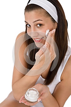 Beauty facial care - Young woman apply moisturizer