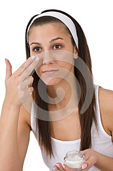 Beauty facial care - Young woman apply moisturizer