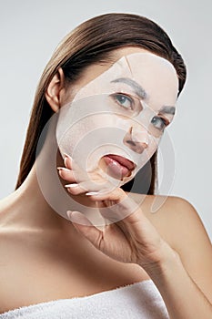 Beauty Facial Mask.  Woman with a cloth moisturizing mask on face .Skin care .Cosmetic  spa mask