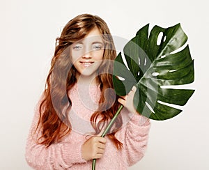 Beauty and fashion concept: Little curly girl child holding flower