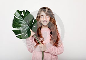 Beauty and fashion concept: Little curly girl child holding flower