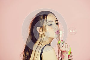 Beauty and fashion. Fun and joy. Bubble blower in hand of fashion model.