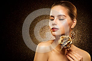 Beauty Fashion Girl glowing golden Skin Care. Beautiful Woman Gold Eye Shadow and Lipstick Make up. Glitters shining