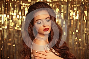 Beauty Fashion Girl Portrait Isolated on golden Christmas glitter lights bokeh Background. Glamour Makeup. Gold Jewelry. Hairstyle