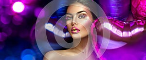 Beauty fashion model girl creative art makeup, over purple, pink and violet air balloons background. Woman face Make-up