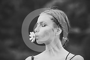 Beauty Fashion model girl. Fashion look. Woman with daisy flower in mouth