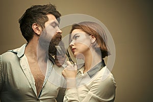 Beauty Fashion model girl. Fashion look. Woman hairdresser cuts beard with scissors. Man with long beard, mustache and