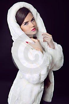 Beauty Fashion Model Girl in Mink Fur Coat and white furry hood.