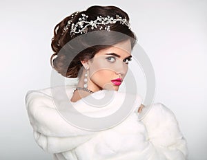 Beauty Fashion Model Girl in white Mink Fur Coat. Wedding hairstyle. Beautiful Luxury Winter Woman isolated on white background.