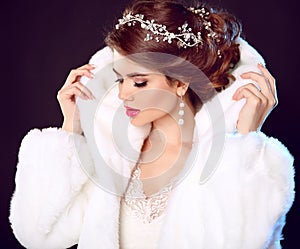 Beauty Fashion Model Girl in white Mink Fur Coat. Wedding hairstyle. Makeup. Beautiful Luxury Winter Woman isolated on dark